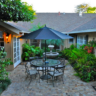 Patio fountain - traditional courtyard patio fountain idea in Orange County with no cover
