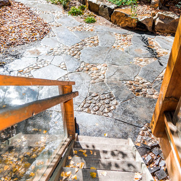 Rundle Stone & River Rock Patio with Rock Retaining Wall Garden