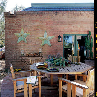 Example of a mountain style brick patio design in Phoenix with no cover