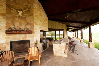 Patio kitchen - rustic patio kitchen idea in Austin