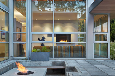 Example of a trendy patio design in Seattle with a fire pit and no cover