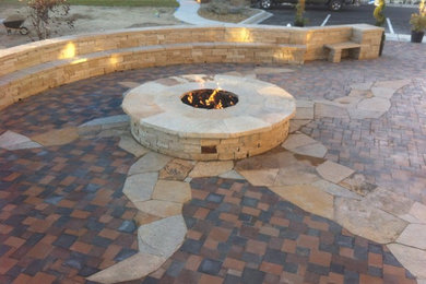 Example of a southwest backyard concrete paver patio design in Albuquerque with a fire pit