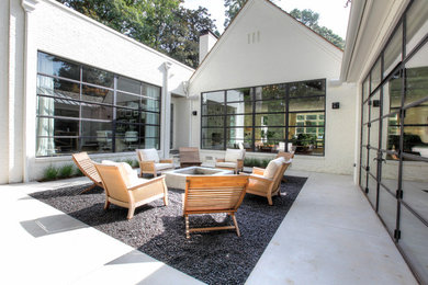 Example of a transitional courtyard gravel patio design in Atlanta with a fire pit