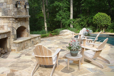 Large elegant backyard stone patio photo in Atlanta with a fire pit and no cover