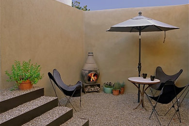 Ejemplo de patio moderno pequeño en patio con brasero y gravilla