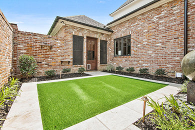 Small trendy courtyard stone patio photo in Other