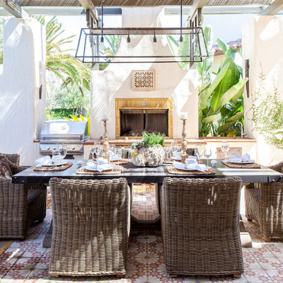 Patio - mediterranean courtyard tile patio idea in Los Angeles with a pergola and a fire pit