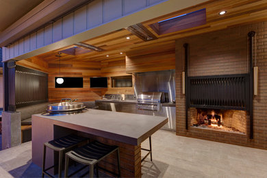Inspiration for a mid-sized contemporary courtyard tile patio kitchen remodel in Portland with a roof extension