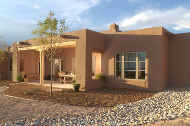 Inspiration for a mid-sized southwestern backyard brick patio remodel in Albuquerque with a pergola