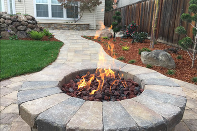 Inspiration for a large contemporary backyard concrete paver patio remodel in San Francisco with a fire pit and no cover