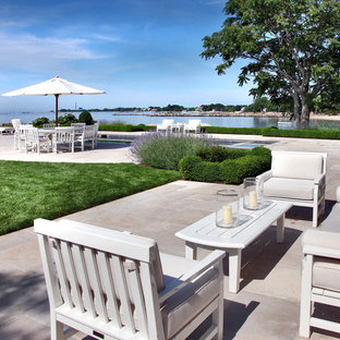 Inspiration for a large contemporary backyard tile patio fountain remodel in New York with no cover