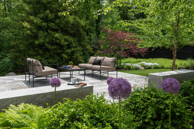 Inspiration for a large contemporary backyard tile patio remodel in Boston with no cover