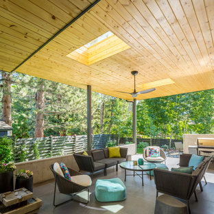 Inspiration for a mid-sized contemporary backyard concrete paver patio remodel in Denver with a roof extension