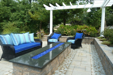 Mid-sized elegant backyard concrete paver patio photo in Philadelphia with a fire pit and a pergola