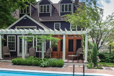 Inspiration for a large timeless backyard patio remodel in Boston with a roof extension