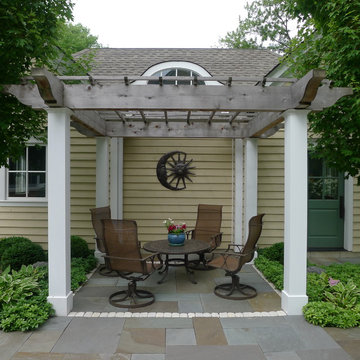 Seating Under Pergola with Sun and Moon Wall Art