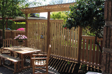Patio - mid-sized craftsman backyard patio idea in Seattle with a pergola