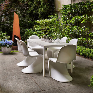 Inspiration for a small industrial side yard concrete paver patio remodel in Austin