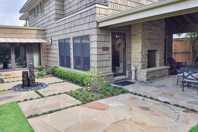 Patio kitchen - mid-sized transitional backyard stone patio kitchen idea in Houston with a roof extension