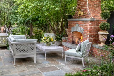 Example of a classic patio design in Denver with a fireplace and no cover