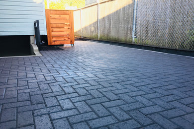 Patio - large modern side yard concrete paver patio idea in Portland with no cover