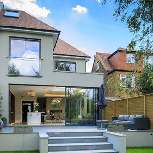 Design ideas for a medium sized contemporary back patio in London with concrete paving and no cover.