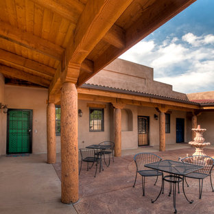 Inspiration for an expansive courtyard patio in Denver with a water feature, concrete slab and no cover.
