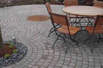 Small trendy courtyard concrete paver patio photo in Seattle with a fire pit