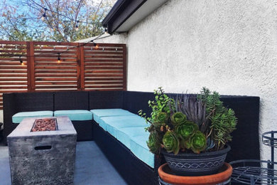 Large minimalist side yard patio photo in Los Angeles with a fire pit and no cover