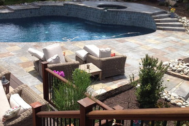 Inspiration for a mid-sized tropical backyard concrete paver patio remodel in Philadelphia with no cover