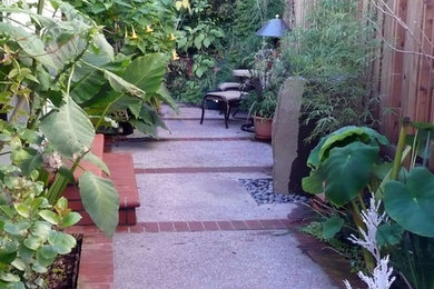 Example of a mid-sized trendy backyard concrete paver patio design in San Francisco with no cover