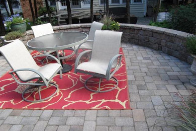 Example of a mid-sized backyard stone patio design in Baltimore