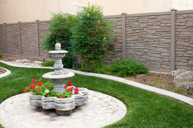 Example of a large minimalist backyard concrete paver patio fountain design in Chicago with no cover