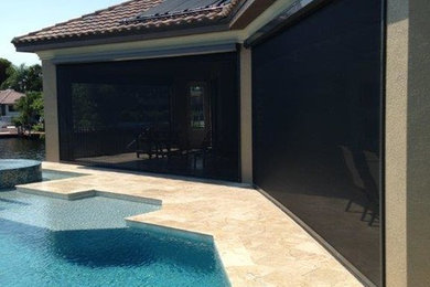 Mid-sized trendy backyard tile patio photo in Miami with a roof extension