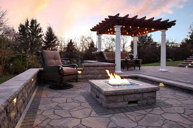 Patio - mid-sized traditional backyard brick patio idea in Philadelphia with a fire pit and a pergola