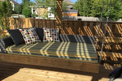 Inspiration for a large timeless backyard patio remodel in Toronto with decking and an awning