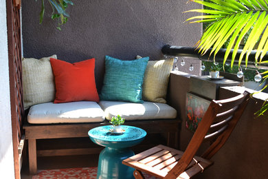 Inspiration for a small tropical patio remodel in Los Angeles with a roof extension