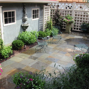 Foto di un patio o portico american style di medie dimensioni e nel cortile laterale con fontane e pavimentazioni in mattoni