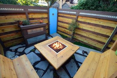 Design ideas for a small rustic back patio in Baltimore with a fire feature, natural stone paving and no cover.
