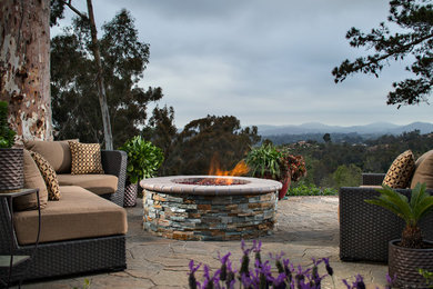 Large trendy backyard concrete paver patio photo in San Diego with a fire pit and no cover