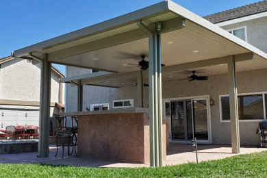 Design ideas for a large traditional back patio with an outdoor kitchen, stamped concrete and a gazebo.