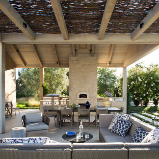 Immagine di un patio o portico country dietro casa con un tetto a sbalzo