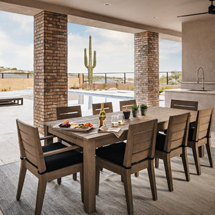 Patio kitchen - large contemporary backyard stone patio kitchen idea in Phoenix with a roof extension