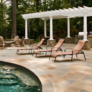 Ispirazione per un patio o portico chic con pavimentazioni in pietra naturale e una pergola