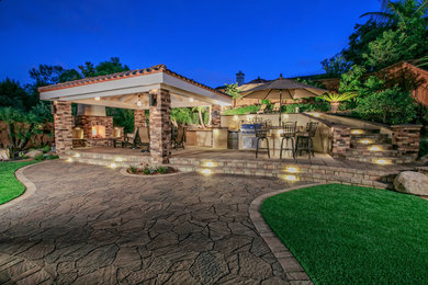 Inspiration for a mid-sized timeless backyard stone patio kitchen remodel in San Diego with a gazebo