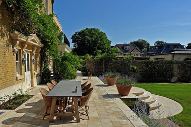 This is an example of a classic back patio in London with no cover.