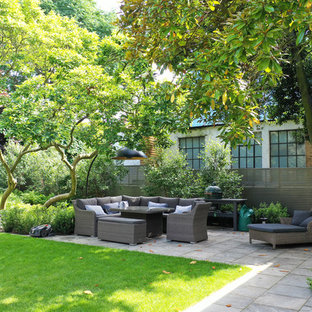 Inspiration for a classic back patio in London with tiled flooring and no cover.