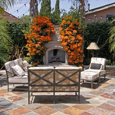 Patio - mediterranean courtyard patio idea in Orange County with a fire pit