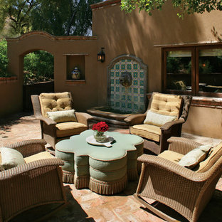 Idee per un patio o portico stile americano con pavimentazioni in mattoni e fontane