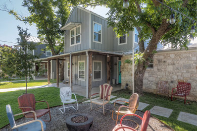 Example of a small farmhouse front yard gravel patio design in Austin with no cover and a fire pit